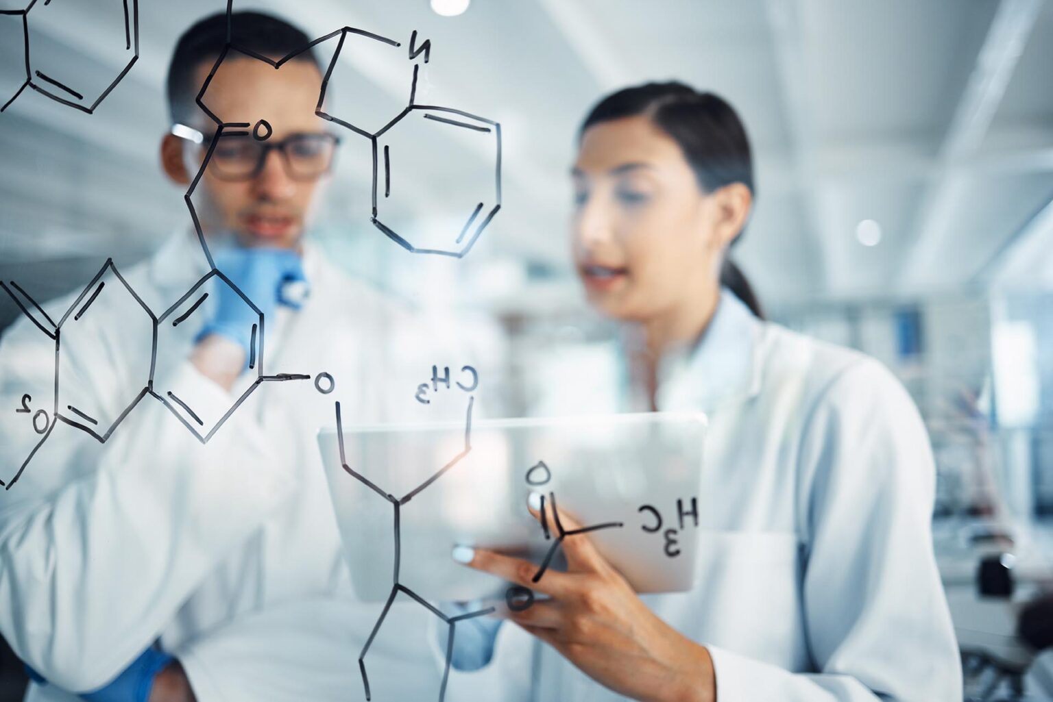 Science, tablet and man and woman with chemistry equation for medical research, formula and solution. Healthcare, teamwork and male and female scientist thinking, planning and strategy in laboratory